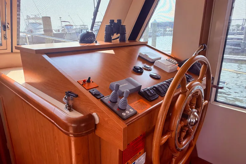  Yacht Photos Pics 2008 Mainship 34 Trawler helm with wooden wheel and navigation controls.