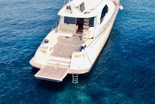  Yacht Photos Pics Aerial view of 2008 Mochi Craft 54' Dolphin yacht on clear blue water.