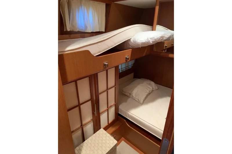 Yacht Photos Pics Interior cabin of 2008 Mochi Craft 54' Dolphin yacht with bunk beds and wooden finish.
