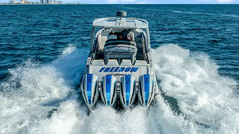  Yacht Photos Pics 2022 Deep Impact 399 Cabin boat cruising on open ocean with powerful engines.