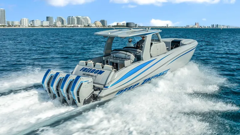  Yacht Photos Pics 2022 Deep Impact 399 Cabin boat cruising on ocean near city skyline.