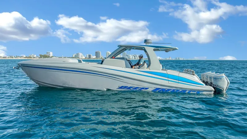  Yacht Photos Pics 2022 Deep Impact 399 Cabin boat cruising on blue ocean under clear sky.