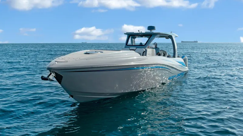  Yacht Photos Pics 2022 Deep Impact 399 Cabin boat on open water under blue sky.