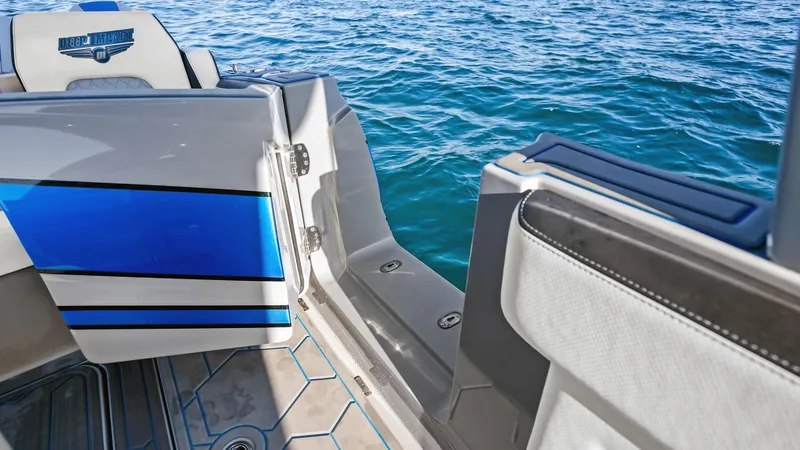  Yacht Photos Pics 2022 Deep Impact 399 Cabin boat with open deck, blue accents, and ocean view.