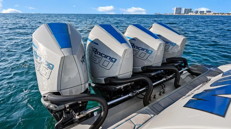  Yacht Photos Pics Four powerful outboard engines on a 2022 Deep Impact 399 Cabin boat, ocean backdrop.