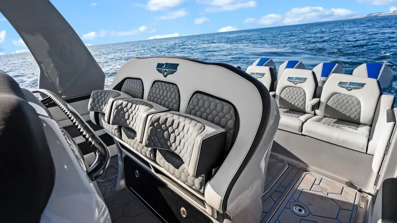  Yacht Photos Pics 2022 Deep Impact 399 Cabin boat interior with luxurious seating, ocean view in background.