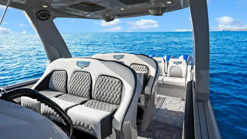  Yacht Photos Pics 2022 Deep Impact 399 Cabin boat interior with luxury seating on open ocean.