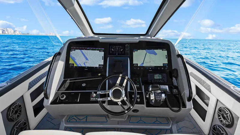  Yacht Photos Pics 2022 Deep Impact 399 Cabin boat cockpit with advanced navigation systems on open sea.