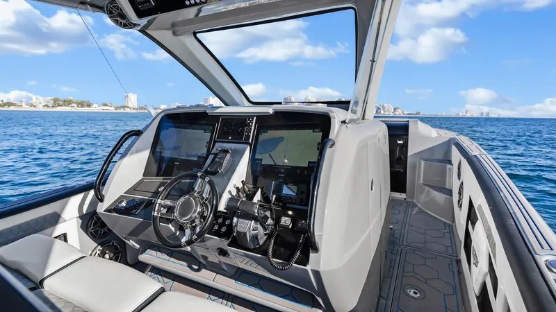  Yacht Photos Pics 2022 Deep Impact 399 Cabin boat interior with modern dashboard and ocean view.