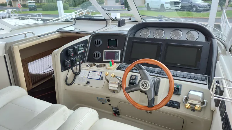 Drifter Yacht Photos Pics 2005 Sea Ray 390 Motor Yacht helm with modern navigation instruments and wooden steering wheel.