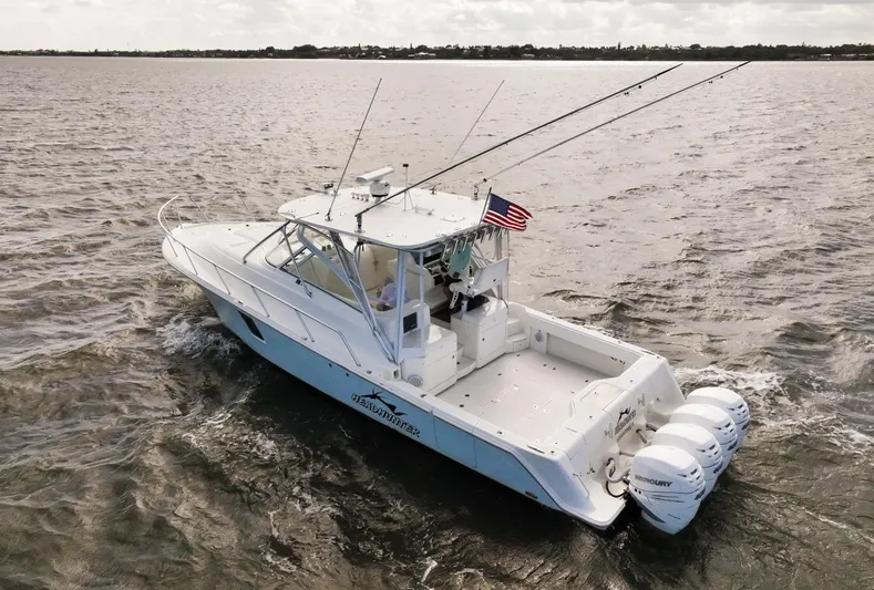 Headhunter Yacht Photos Pics 2010 SeaVee 430 Sport Express boat cruising on open water with fishing rods.