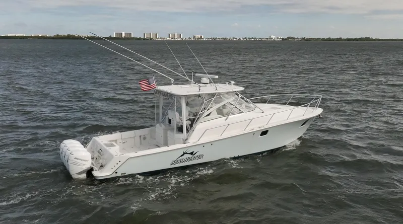 Headhunter Yacht Photos Pics 2010 SeaVee 430 Sport Express boat cruising on open water with city skyline in background.