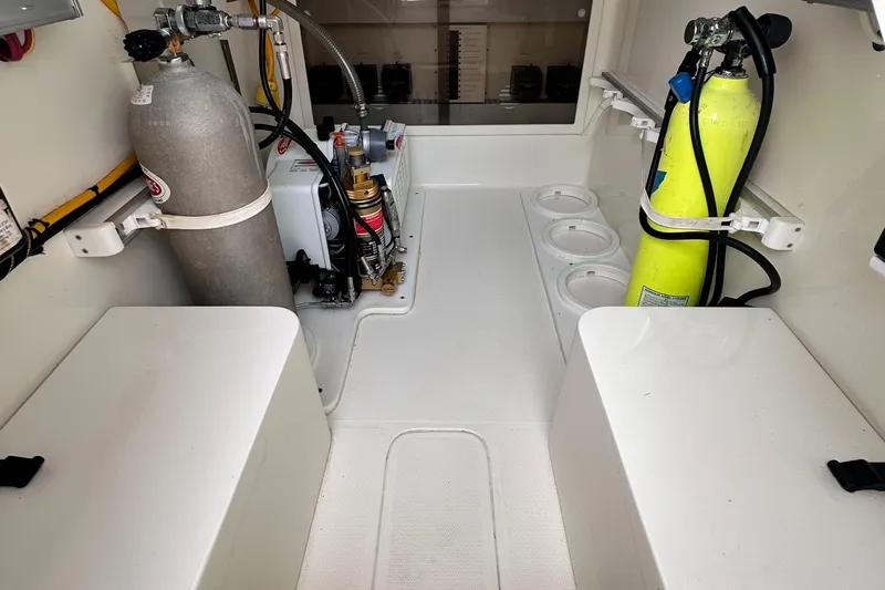 Headhunter Yacht Photos Pics Engine room of 2010 SeaVee 430 Sport Express with scuba tanks and equipment.
