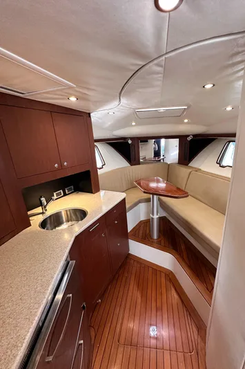 Headhunter Yacht Photos Pics 2010 SeaVee 430 Sport Express interior with wood flooring and compact kitchenette.
