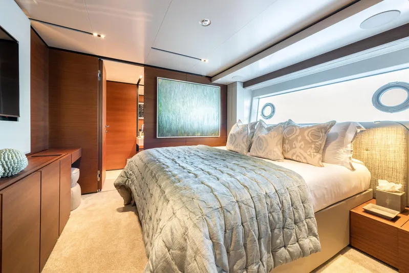 Mac One Yacht Photos Pics Luxurious bedroom interior on 2019 Custom Line Navetta 33 yacht, featuring elegant decor and plush bedding.