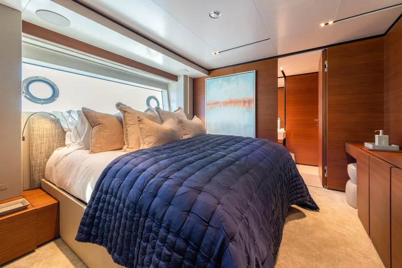 Mac One Yacht Photos Pics Luxurious bedroom interior on 2019 Custom Line Navetta 33 yacht, featuring elegant decor and plush bedding.