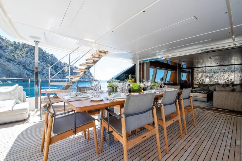 Mac One Yacht Photos Pics Luxurious 2019 Custom Line Navetta 33 yacht with elegant outdoor dining area and scenic ocean view.
