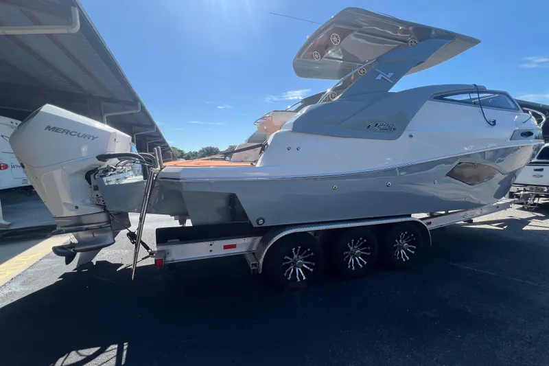  Yacht Photos Pics 2024 NX Boats 290 Exclusive on trailer, featuring Mercury outboard engine.