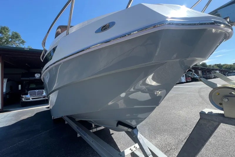  Yacht Photos Pics 2024 NX Boats 290 Exclusive on trailer, sleek design under bright blue sky.