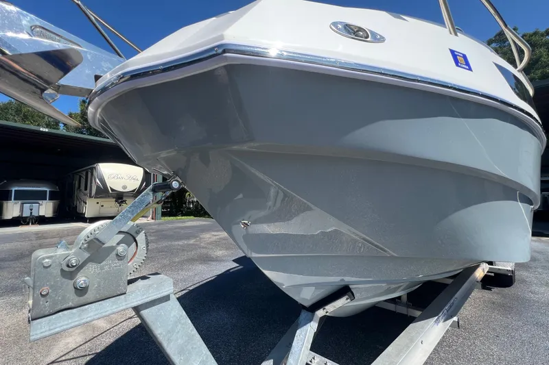  Yacht Photos Pics 2024 NX Boats 290 Exclusive on trailer, showcasing sleek hull design.