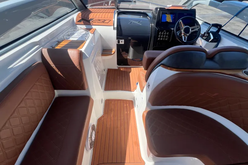  Yacht Photos Pics 2024 NX Boats 290 Exclusive interior with luxurious brown leather seating and modern dashboard.