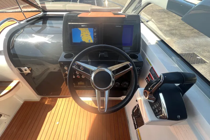  Yacht Photos Pics 2024 NX Boats 290 Exclusive dashboard with steering wheel and navigation screens.
