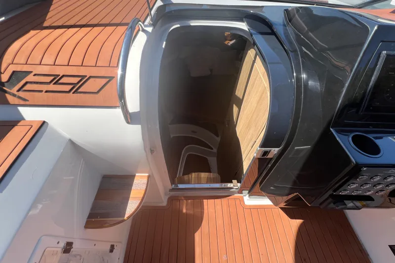  Yacht Photos Pics 2024 NX Boats 290 Exclusive cockpit with teak flooring and sleek black console.