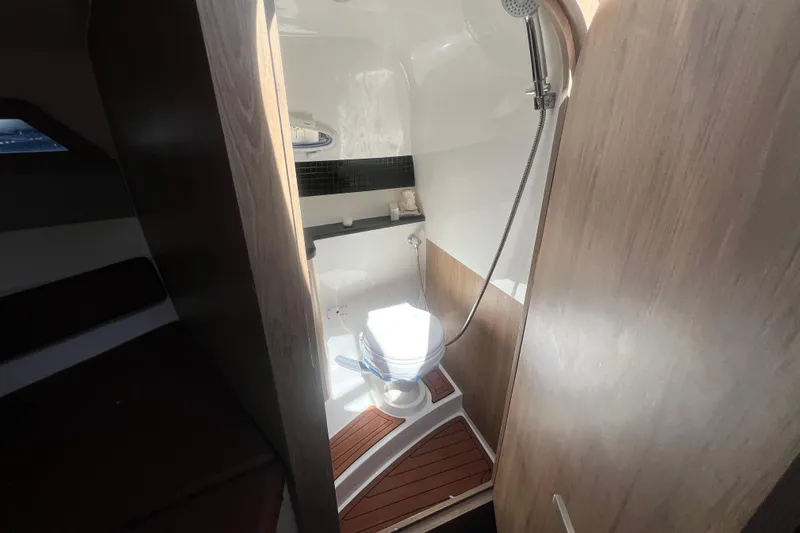  Yacht Photos Pics 2024 NX Boats 290 Exclusive bathroom with shower and wooden flooring.