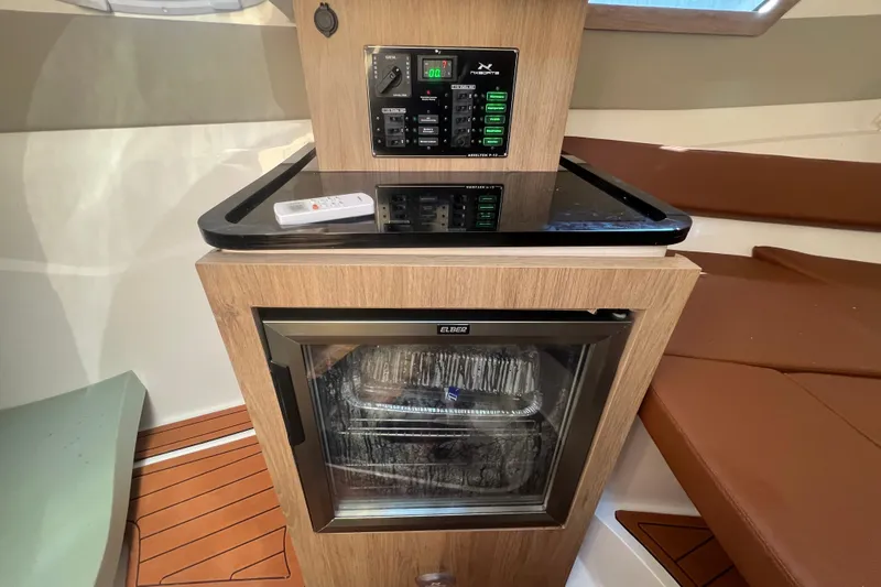  Yacht Photos Pics 2024 NX Boats 290 Exclusive interior with control panel and mini fridge.