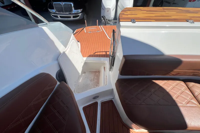  Yacht Photos Pics 2024 NX Boats 290 Exclusive interior with brown leather seats and storage compartment.