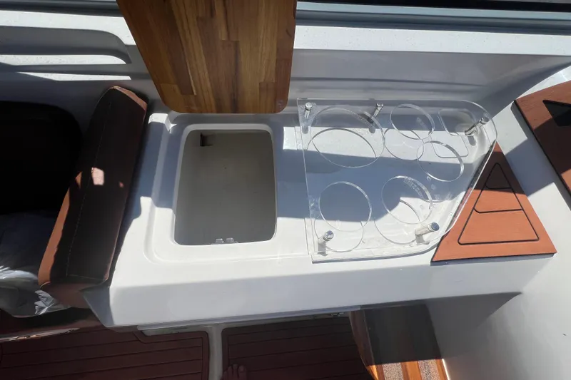  Yacht Photos Pics 2024 NX Boats 290 Exclusive interior with cup holders and storage compartment.