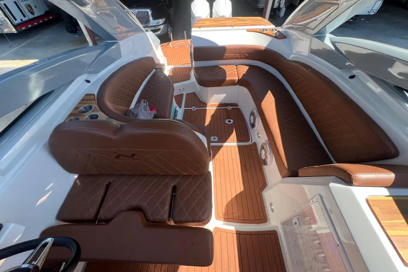  Yacht Photos Pics 2024 NX Boats 290 Exclusive interior with luxurious brown leather seating and wood accents.