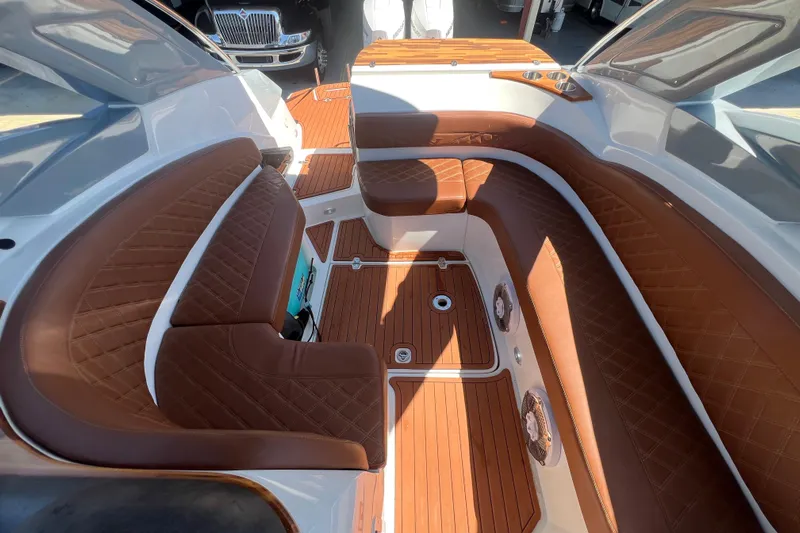  Yacht Photos Pics 2024 NX Boats 290 Exclusive interior with luxurious brown leather seating and wood flooring.