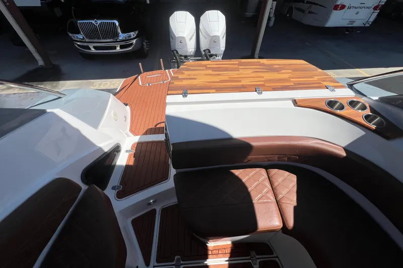  Yacht Photos Pics 2024 NX Boats 290 Exclusive interior with brown leather seating and wood accents.