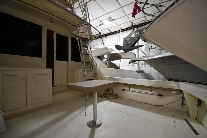 Patience III Yacht Photos Pics 1988 Viking 48 Convertible yacht interior with ladder and table in a storage facility.
