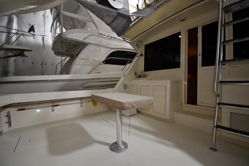 Patience III Yacht Photos Pics 1988 Viking 48 Convertible yacht interior with table and ladder in a marina setting.