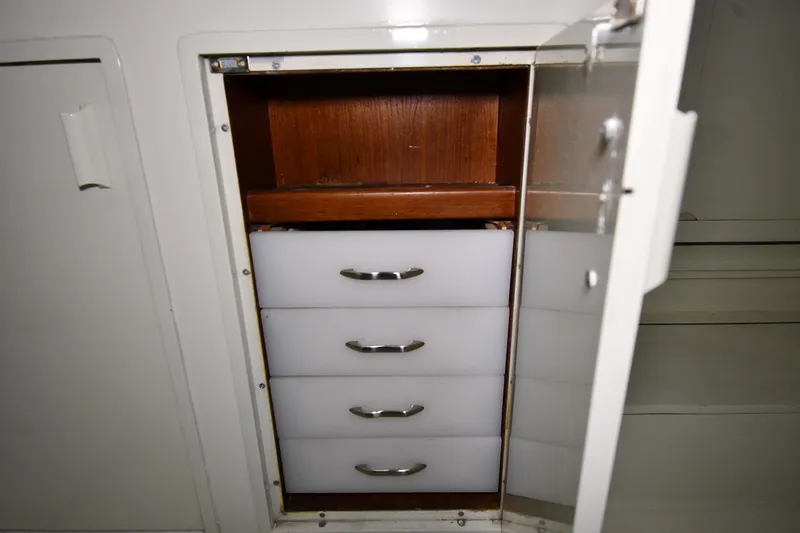 Patience III Yacht Photos Pics Open cabinet with four white drawers on a 1988 Viking 48 Convertible boat.