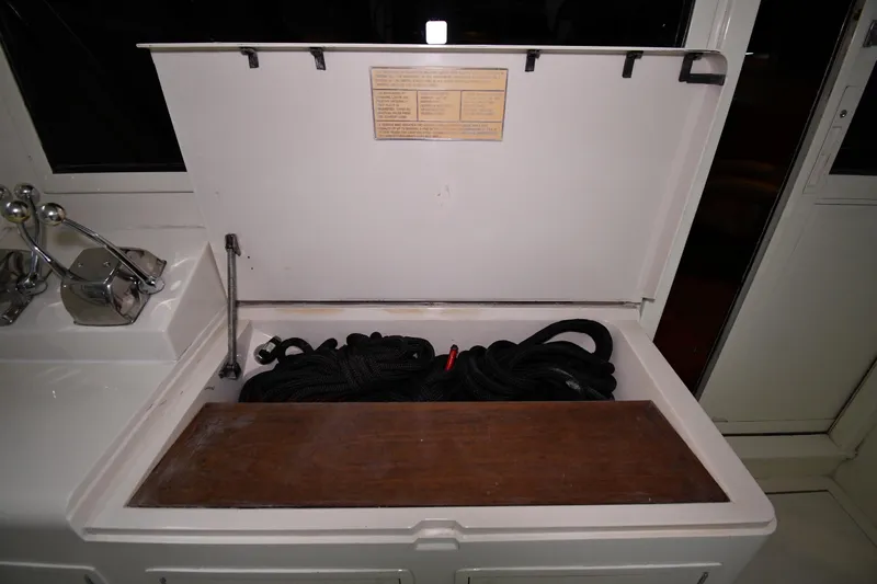 Patience III Yacht Photos Pics Storage compartment on a 1988 Viking 48 Convertible boat with coiled rope inside.