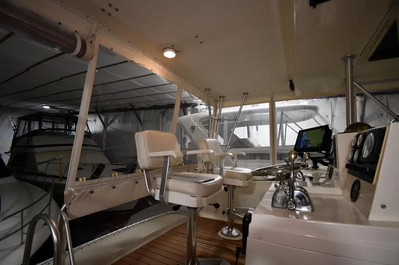 Patience III Yacht Photos Pics Interior view of 1988 Viking 48 Convertible yacht helm with controls and seating.