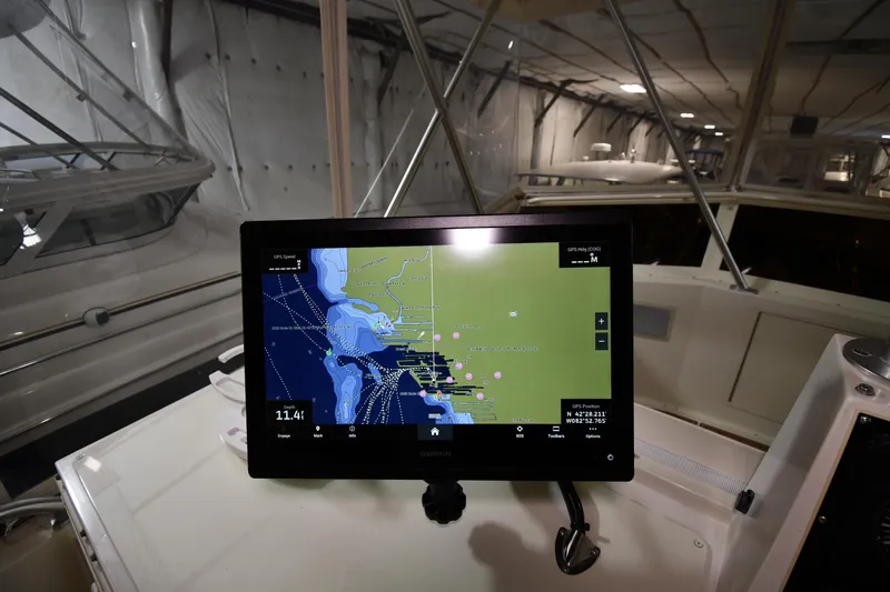 Patience III Yacht Photos Pics Navigation screen on 1988 Viking 48 Convertible yacht, displaying nautical map in a covered marina.