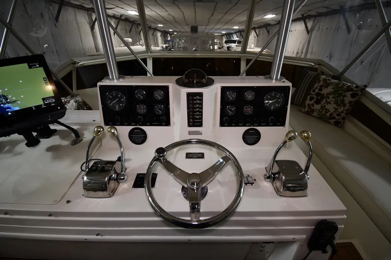 Patience III Yacht Photos Pics 1988 Viking 48 Convertible yacht helm with steering wheel and navigation controls.