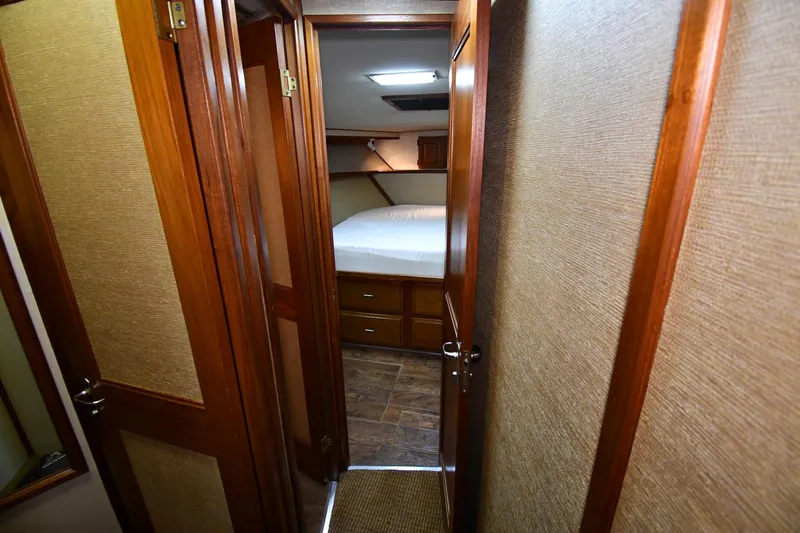 Patience III Yacht Photos Pics Interior cabin of 1988 Viking 48 Convertible yacht with wooden doors and cozy bed.
