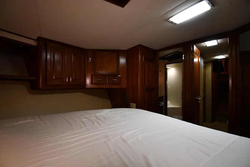 Patience III Yacht Photos Pics Interior of 1988 Viking 48 Convertible yacht with wood cabinetry and cozy bedroom.