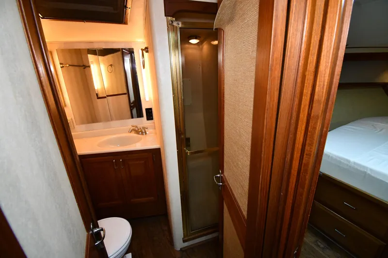 Patience III Yacht Photos Pics 1988 Viking 48 Convertible yacht bathroom with wooden cabinetry and shower.