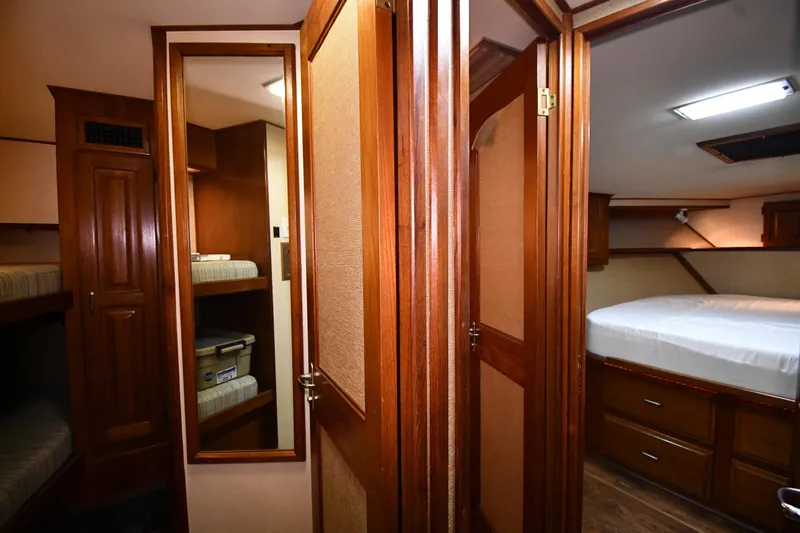 Patience III Yacht Photos Pics Interior of 1988 Viking 48 Convertible yacht with wooden cabinetry and cozy sleeping quarters.