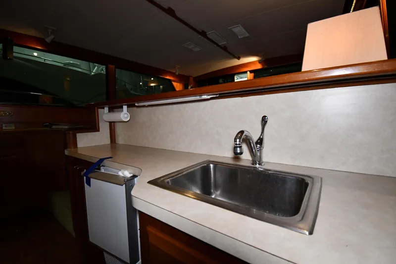Patience III Yacht Photos Pics Interior of 1988 Viking 48 Convertible yacht kitchen with sink and countertop.