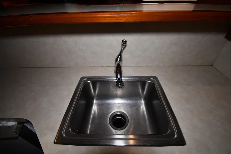 Patience III Yacht Photos Pics Stainless steel sink with faucet in 1988 Viking 48 Convertible yacht kitchen.