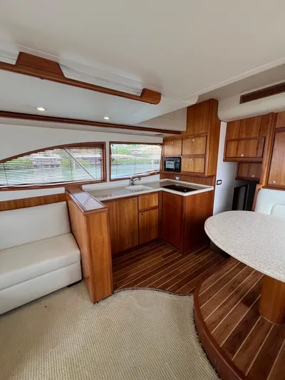 No Name Yacht Photos Pics Interior of a 2009 Bertram Convertible yacht with wood finishes and modern amenities.