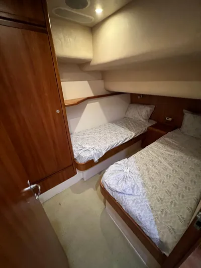 No Name Yacht Photos Pics 2009 Bertram Convertible cabin with twin beds and wooden interior.