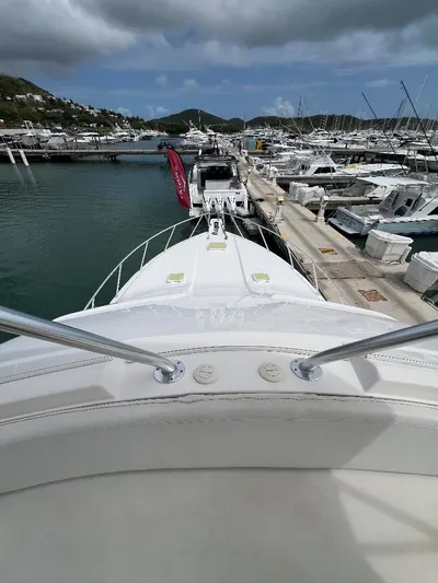 No Name Yacht Photos Pics 2009 Bertram Convertible yacht docked in a marina with scenic mountain backdrop.